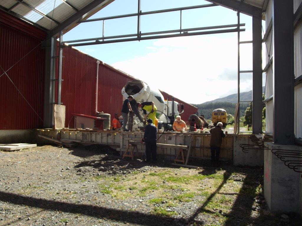 Trust volunteers placing concrete into formwork from Higgins concrete truck 