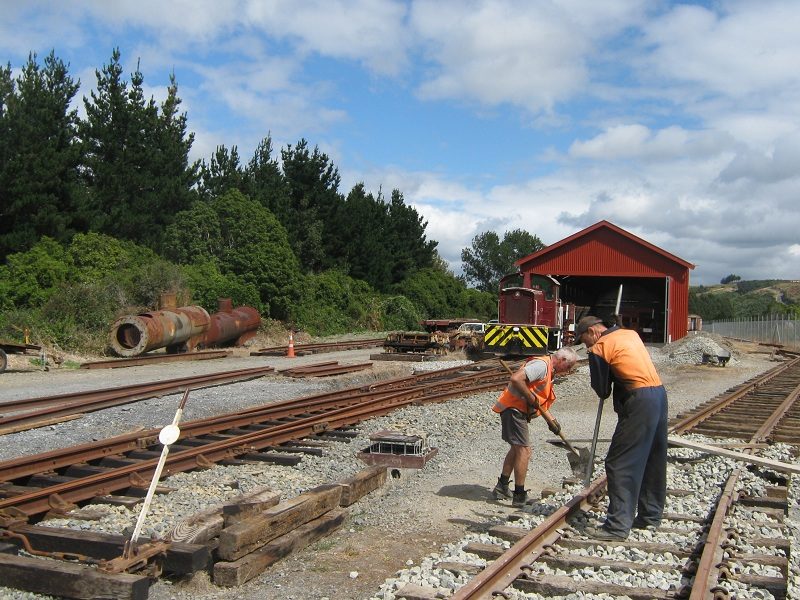 John and Hugh tamping ballast on turntable road, Tr189 in background.