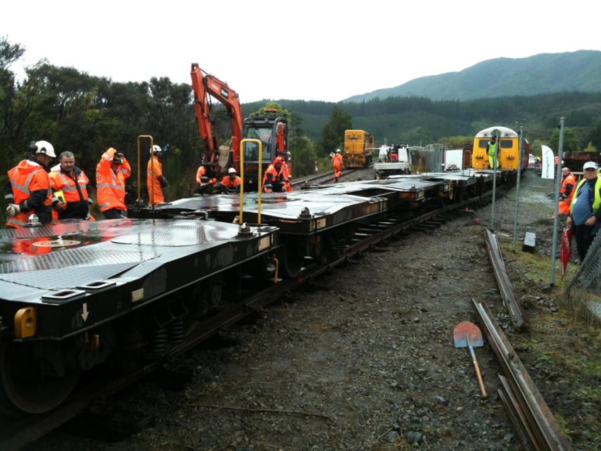 KiwiRail track staff keep a careful watch whilst Cyclops is propelled through the slew. Photo: Hugh McCracken