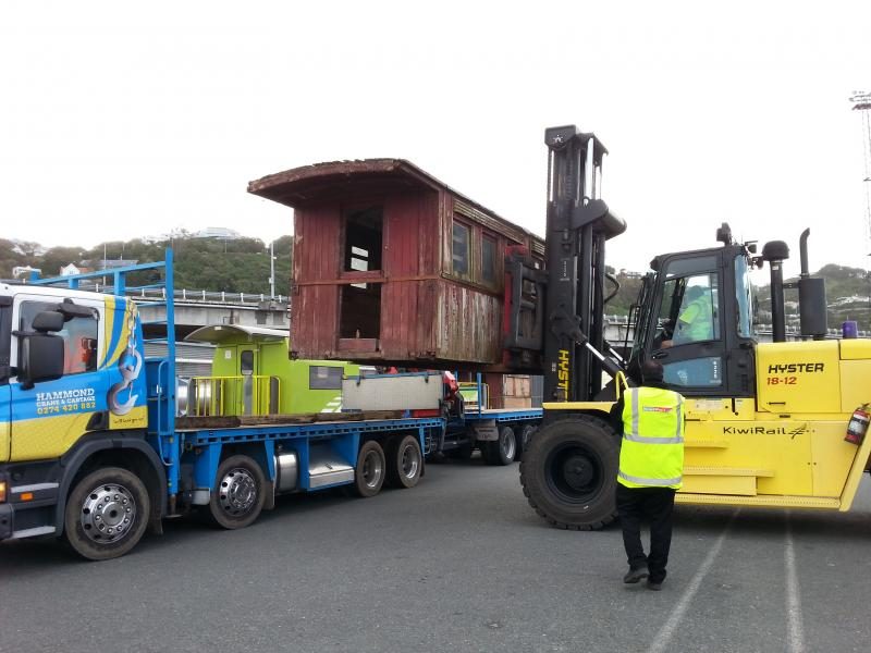 KiwiRail staff help transfer the carriage bodies from rail wagon to hiab truck