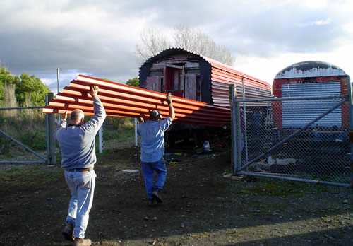 Cladding carriage with long-run roofing