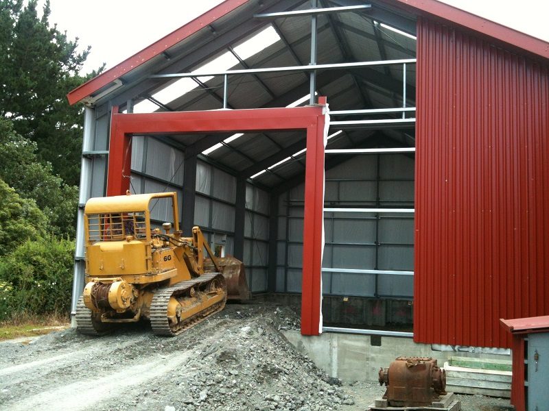 An earth ramp was graded up and across the foundation wall, and successive loads pushed down into the foundation area