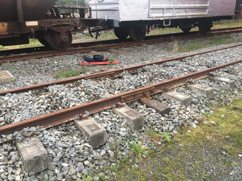 A joint has been lifted and packed in the yard near the rail vehicle shed.