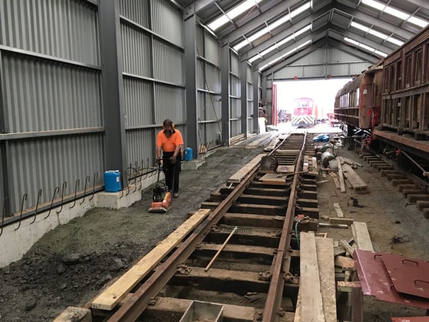 Compacting fill into place, north side of shed