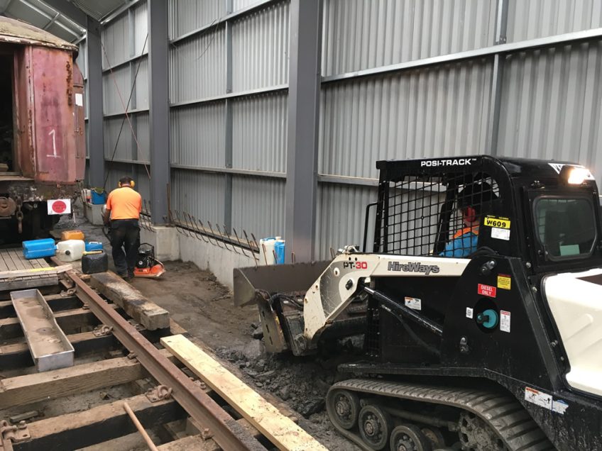 Tracked loader on north side of shed